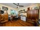 This home office features wooden floors, a ceiling fan, and plenty of storage and natural light at 3174 Eagles Landing W Cir # 58, Clearwater, FL 33761