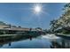 Picturesque water view with fountain surrounded by lush trees and neighborhood homes, creating a serene ambiance at 3174 Eagles Landing W Cir # 58, Clearwater, FL 33761