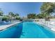 Inviting community pool with shallow end, surrounded by lounge chairs and lush landscaping, perfect for relaxation at 3174 Eagles Landing W Cir # 58, Clearwater, FL 33761