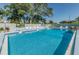 Inviting community pool with lounge chairs and tables, perfect for relaxation and socializing at 3174 Eagles Landing W Cir # 58, Clearwater, FL 33761