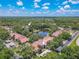 A beautiful aerial view showcasing the community pool, clubhouse, and a serene lake at 3505 Tarpon Woods Blvd # N405, Palm Harbor, FL 34685