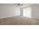 Spacious carpeted bedroom with natural light and a ceiling fan at 3505 Tarpon Woods Blvd # N405, Palm Harbor, FL 34685