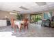 A clubhouse interior offers a dining area with a table, chairs, and sliding doors to the outside at 3505 Tarpon Woods Blvd # N405, Palm Harbor, FL 34685