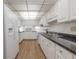 The kitchen features white cabinets, black counters and plenty of storage at 3505 Tarpon Woods Blvd # N405, Palm Harbor, FL 34685
