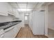 Bright kitchen features white cabinets and a full-size refrigerator at 3505 Tarpon Woods Blvd # N405, Palm Harbor, FL 34685