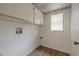 This laundry room features a window and white cabinets for ample storage space at 3505 Tarpon Woods Blvd # N405, Palm Harbor, FL 34685