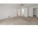 Spacious living room with carpet, featuring multiple entryways and neutral-colored walls at 3505 Tarpon Woods Blvd # N405, Palm Harbor, FL 34685