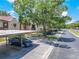 Street view featuring assigned covered parking and mature trees enhancing the property's appeal at 3505 Tarpon Woods Blvd # N405, Palm Harbor, FL 34685
