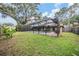A screened-in pool, patio, and backyard surrounded by lush greenery at 3604 Arlington Oaks Ct, Tampa, FL 33618