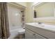 A well-lit bathroom featuring a single sink, a mirror, and a shower-tub combo at 3604 Arlington Oaks Ct, Tampa, FL 33618