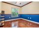 A cozy bedroom features hardwood floors and a bright window at 3604 Arlington Oaks Ct, Tampa, FL 33618