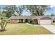 Charming single-story home with stone accents, mature trees, and a well-maintained lawn at 3604 Arlington Oaks Ct, Tampa, FL 33618