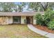 Charming home exterior with stone accents, updated landscaping, and inviting walkway at 3604 Arlington Oaks Ct, Tampa, FL 33618