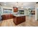 Well-lit kitchen featuring a center island, modern appliances, and views of outdoor living space at 3604 Arlington Oaks Ct, Tampa, FL 33618