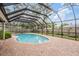 Backyard pool featuring a screened-in enclosure and brick-paved patio at 3604 Arlington Oaks Ct, Tampa, FL 33618
