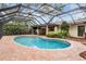 A screened-in pool area with a brick patio and lush landscaping at 3604 Arlington Oaks Ct, Tampa, FL 33618