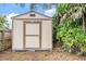 Backyard shed offering extra storage space, nestled among the trees at 3604 Arlington Oaks Ct, Tampa, FL 33618