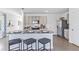 Modern kitchen with stainless steel appliances, granite countertops, and a three-seat breakfast bar at 36123 Sunflower Hill Dr, Zephyrhills, FL 33541