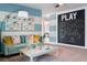 Playroom featuring a comfortable sofa, colorful artwork, and a chalkboard wall with playful designs at 37255 Sagemoor Dr, Zephyrhills, FL 33541