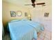 Bedroom with tiled floors, two beds, and neutral walls with decorative wall art at 3845 Edgemont Dr, New Port Richey, FL 34652
