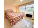 Bedroom with tiled floors, a decorative bed frame, and natural light from the window at 3845 Edgemont Dr, New Port Richey, FL 34652