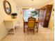 Light-filled dining room boasts tiled floors and a wooden table with seating for four at 3845 Edgemont Dr, New Port Richey, FL 34652