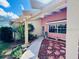 Exterior view of a home's front entrance, featuring a decorative walkway and a covered entryway at 3845 Edgemont Dr, New Port Richey, FL 34652