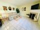 Cozy living room with tile flooring, a fireplace, comfortable seating, and a television at 3845 Edgemont Dr, New Port Richey, FL 34652