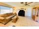 Spacious living room has tiled floors, comfortable couch, and a ceiling fan to circulate air at 3845 Edgemont Dr, New Port Richey, FL 34652