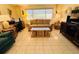This living room offers a cozy couch, tiled floors, and natural light from the large window at 3845 Edgemont Dr, New Port Richey, FL 34652