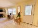 Bright living area featuring tile floors, a large window, and a cozy desk setup by the front door at 3845 Edgemont Dr, New Port Richey, FL 34652