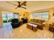 Living room showcases tile floors, comfortable seating, and sliding glass doors to the lanai at 3845 Edgemont Dr, New Port Richey, FL 34652