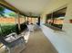 Spacious outdoor patio with ample seating, ceiling fan, and views of the well-maintained backyard at 3845 Edgemont Dr, New Port Richey, FL 34652