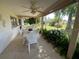 Covered patio with ample seating and lush greenery, ideal for outdoor relaxation and dining at 3845 Edgemont Dr, New Port Richey, FL 34652