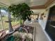 Covered patio with seating and a garden, perfect for enjoying the outdoors in a tranquil setting at 3845 Edgemont Dr, New Port Richey, FL 34652