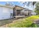 Backyard view of a screened porch attached to the property at 39650 Us Highway 19 N # 553, Tarpon Springs, FL 34689