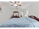 Bedroom features a ceiling fan, dresser, and views to the hallway and another bedroom at 39650 Us Highway 19 N # 553, Tarpon Springs, FL 34689