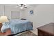 Cozy bedroom with ceiling fan, neutral walls and carpet, and furnishings at 39650 Us Highway 19 N # 553, Tarpon Springs, FL 34689