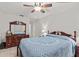 Bedroom features a ceiling fan, dresser, and clean neutral walls at 39650 Us Highway 19 N # 553, Tarpon Springs, FL 34689