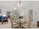 Bright dining area with glass table, vaulted ceilings, and open to the living area at 39650 Us Highway 19 N # 553, Tarpon Springs, FL 34689