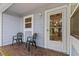 Cozy front porch with brick flooring and seating at 39650 Us Highway 19 N # 553, Tarpon Springs, FL 34689