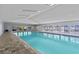 Bright indoor pool with ample seating, creating a refreshing and relaxing environment for residents at 39650 Us Highway 19 N # 553, Tarpon Springs, FL 34689