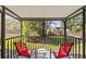 Screened porch with patio chairs and a view of the landscaped backyard at 39650 Us Highway 19 N # 553, Tarpon Springs, FL 34689