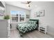 Bright bedroom featuring a leafy-green comforter, white furniture, and light wood flooring at 4120 W North A St # 2, Tampa, FL 33609
