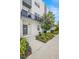 Exterior view of a modern townhome entrance with small balcony and attractive landscaping at 4120 W North A St # 2, Tampa, FL 33609