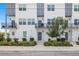 Modern townhome exterior with white facade, gray accents, balconies, and landscaped entrance at 4120 W North A St # 2, Tampa, FL 33609