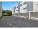 Townhome garages offer convenient parking, with additional spaces on a paved driveway at 4120 W North A St # 2, Tampa, FL 33609