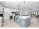 Open kitchen with white and gray cabinets, island seating, stainless steel appliances, and wine cooler at 4120 W North A St # 2, Tampa, FL 33609