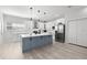 Stylish kitchen with a gray island, white cabinets, stainless steel appliances and modern lighting at 4120 W North A St # 2, Tampa, FL 33609