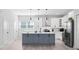 Bright kitchen featuring an island with pendant lights, white cabinets, and stainless steel appliances at 4120 W North A St # 2, Tampa, FL 33609